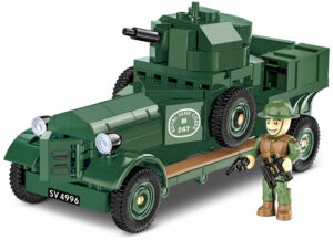 A lego soldier is standing next to a 1:35 scale model of an armored Rolls Royce car.