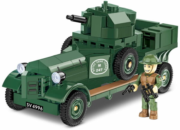 A lego soldier is standing next to a 1:35 scale model of an armored Rolls Royce car.