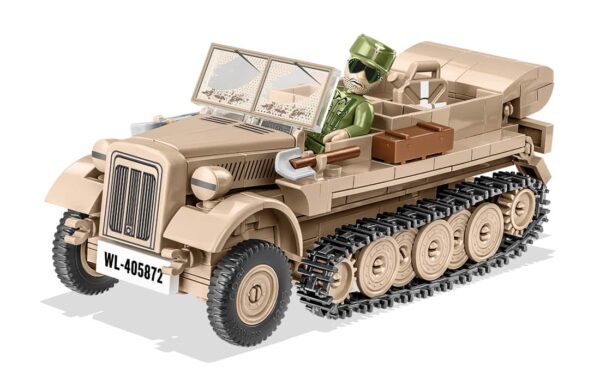 An army vehicle with a man driving, specifically the Sd.Kfz 10 Demag D7 #2273.