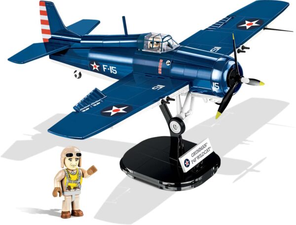 A blue F4F Wildcat - Northrop Grumman #5731 with a man standing next to it.