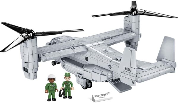 A Bell-Boeing V-22 Osprey model with a man and a woman standing next to it.