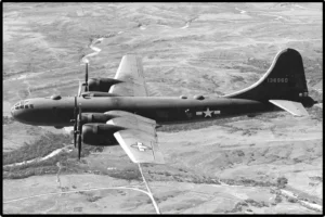 Historical black-and-white reference photo of a Boeing B-29 Superfortress heavy bomber in flight.